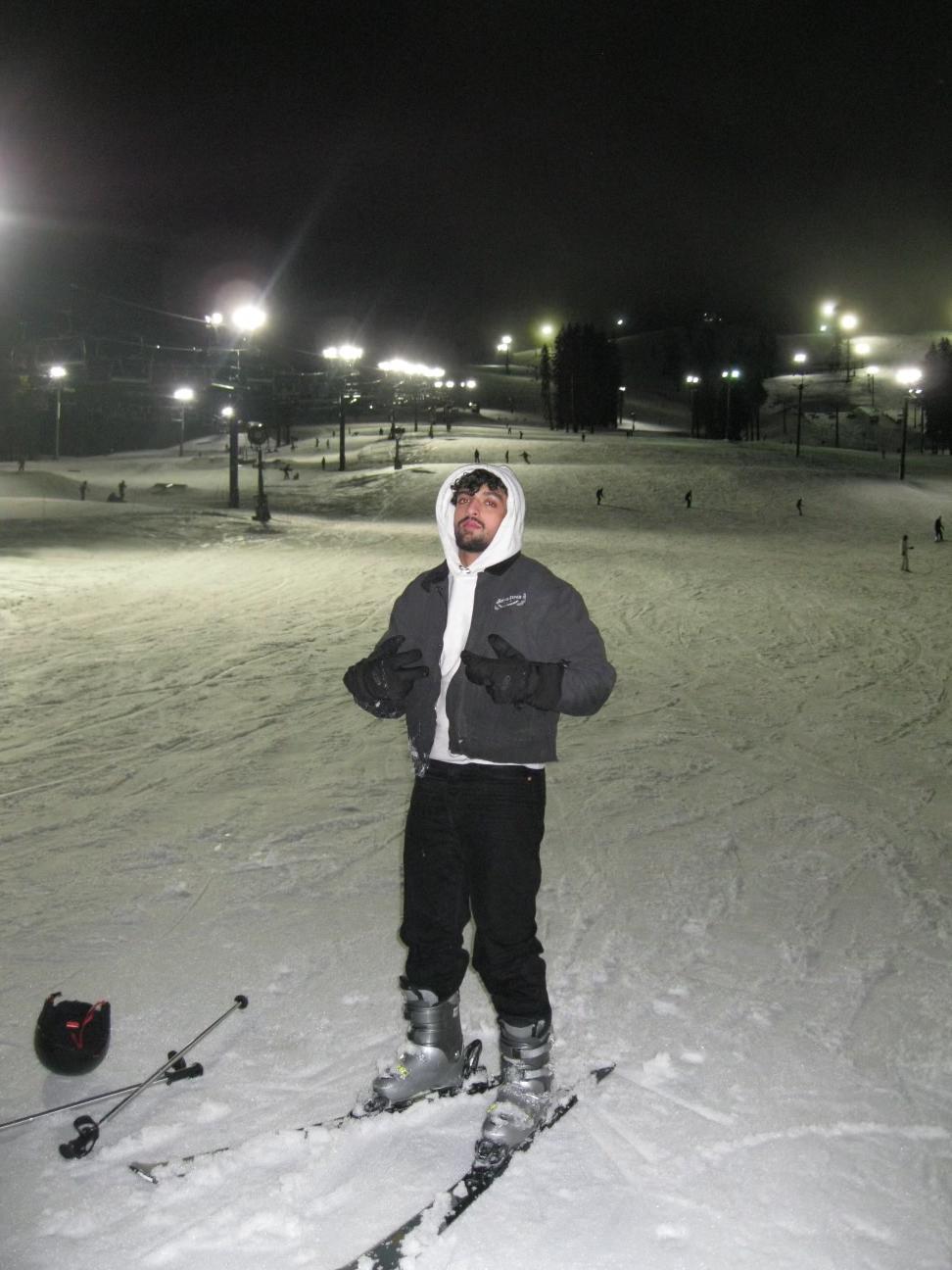 Night skiing, lit by a camera flash.